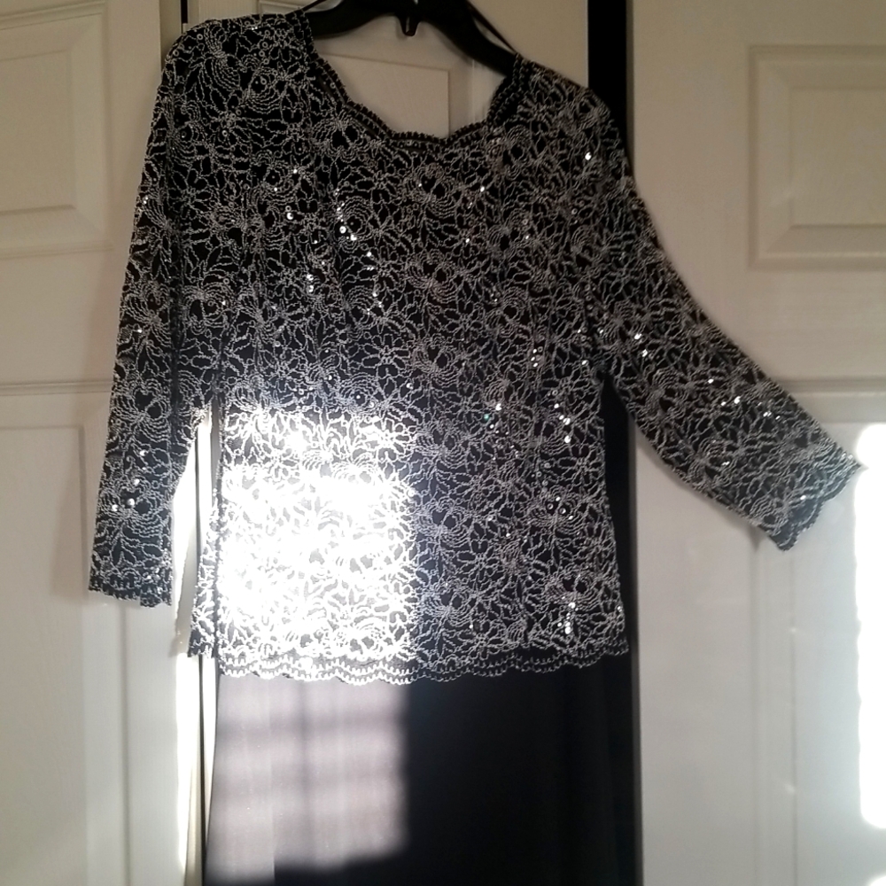 Beautiful neckline, black and sequin dress.